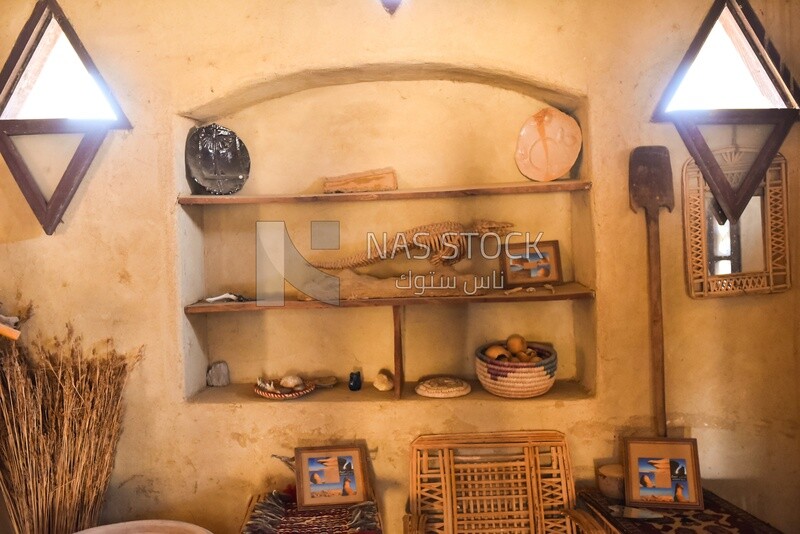 A scene of a wall inside a Bedouin house containing antiques and traditional handicrafts