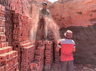 Group of Egyptian craftsmen working in the manufacture of red bricks