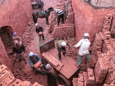 Group of Egyptian craftsmen working in the manufacture of red bricks