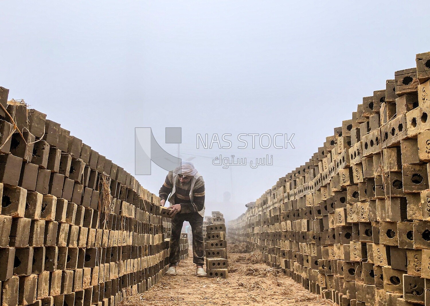 An Egyptian craftsman arranging the bricks