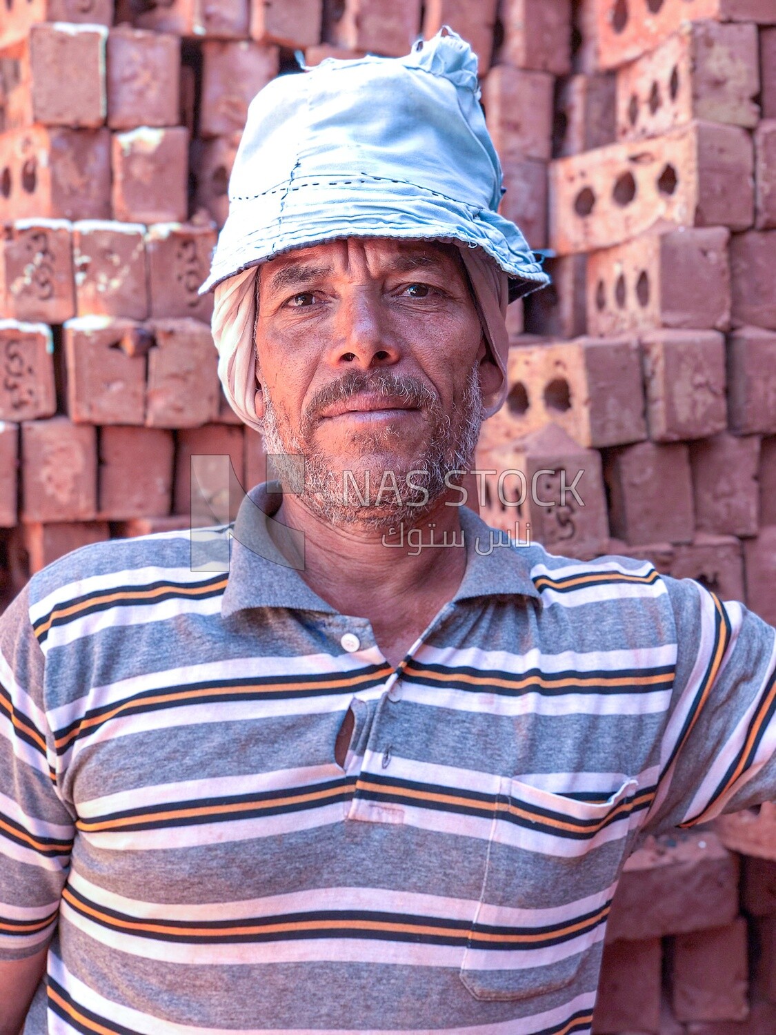 An Egyptian craftsman arranging the bricks