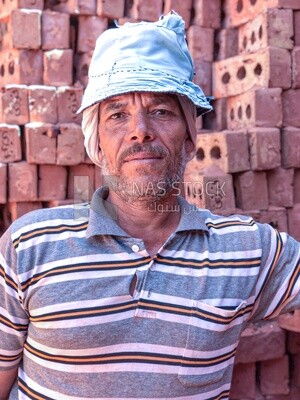 An Egyptian craftsman arranging the bricks