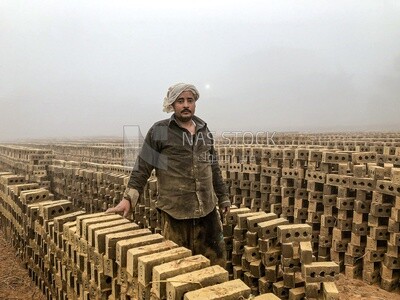 An Egyptian craftsman arranging the bricks