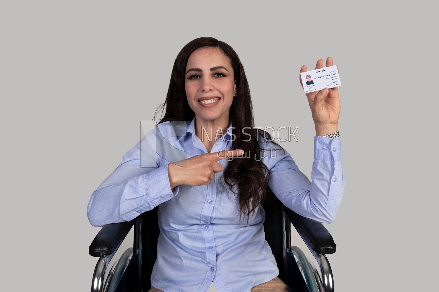 girl sitting in a wheelchair and pointing at an ID card,Services for people with disabilities