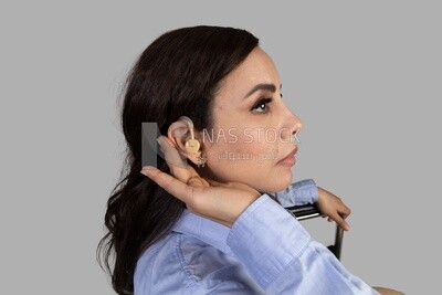 hearing impaired woman trying to use hearing aids for the deaf and mute