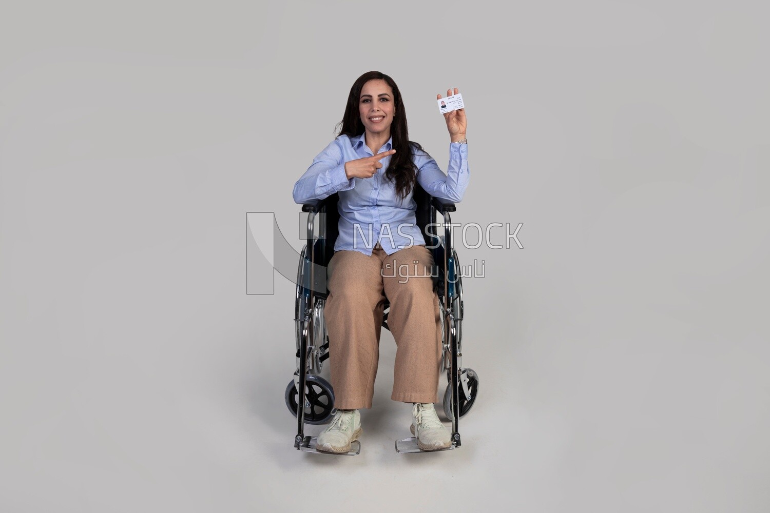 girl sitting in a wheelchair and pointing at an ID card,Services for people with disabilities