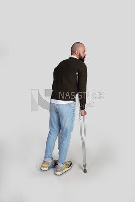 young man with a leg problem and using crutches
