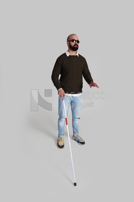 blind man standing wearing glasses and holding a walking stick
