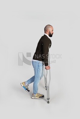young man with a leg problem and using crutches