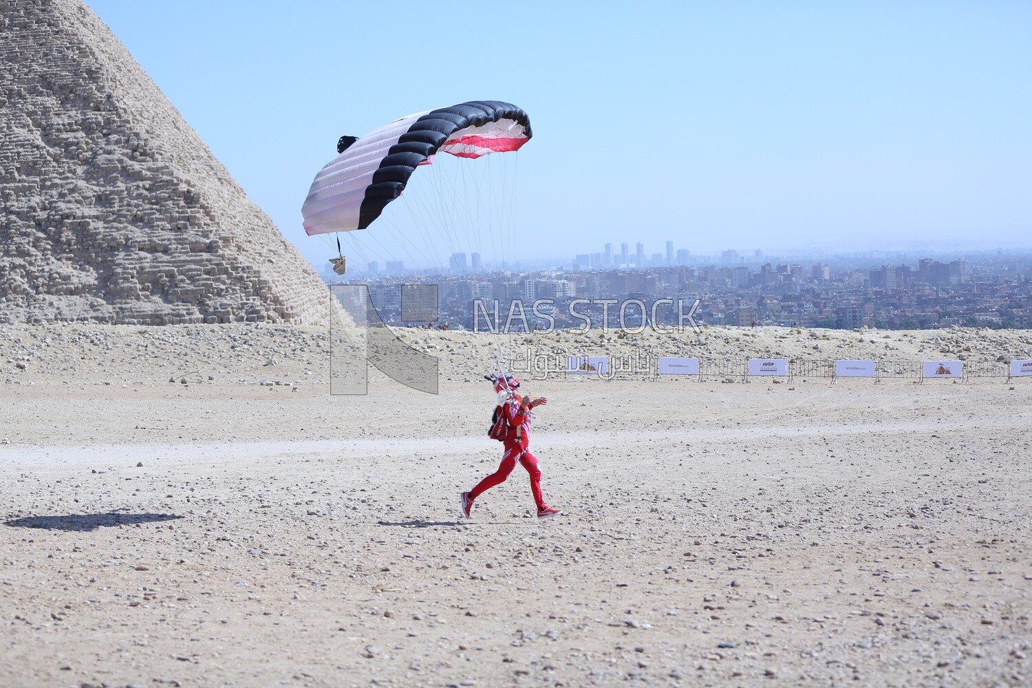 The scene of a person parachuting on the land of the pyramids in Egypt