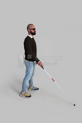 blind man wearing glasses and using a walking stick