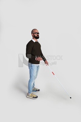 blind man holding a walking stick and wearing glasses
