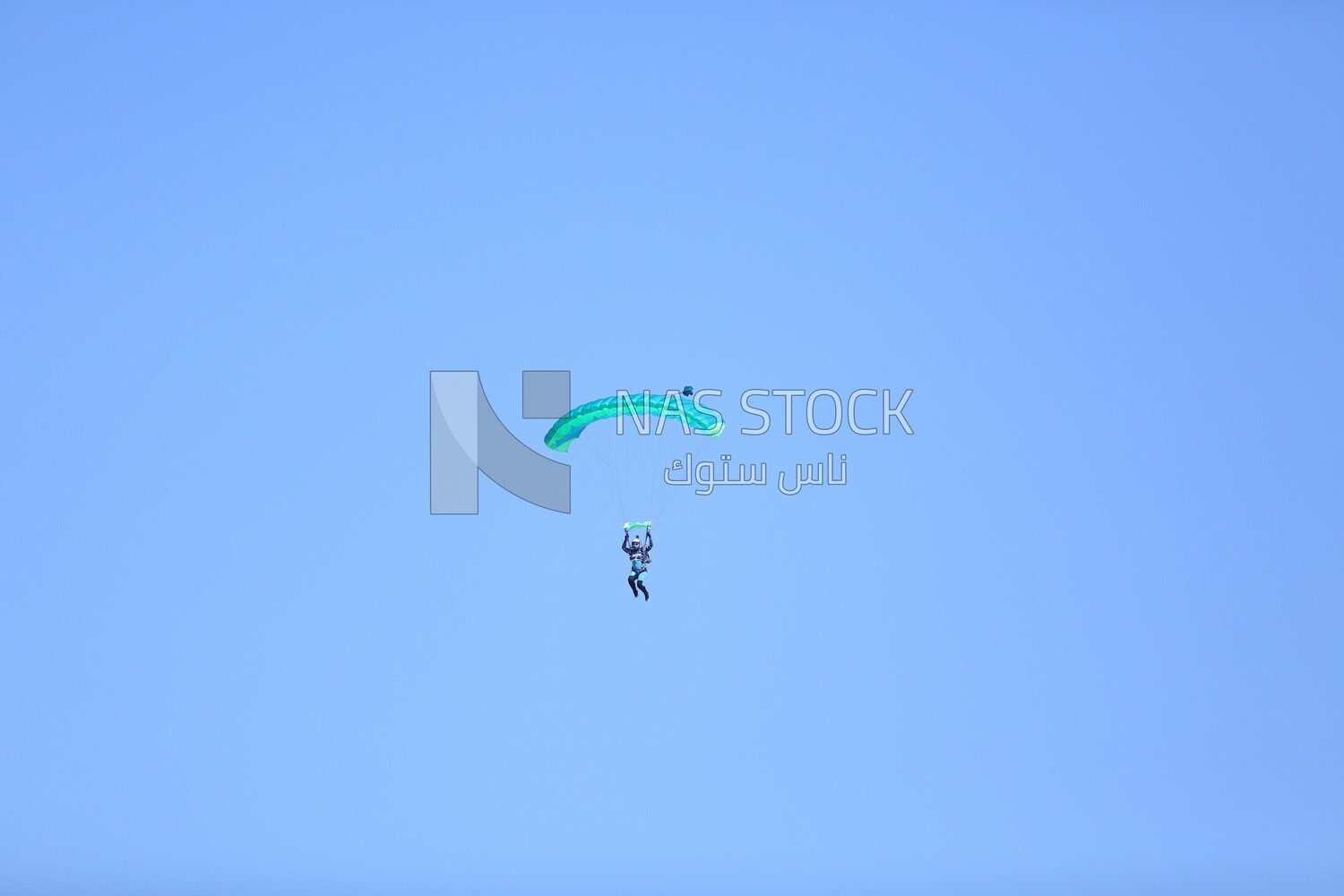 Scene of a person flying in the sky wearing a parachute