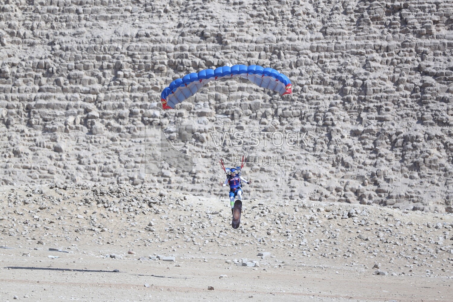 Scene of  people flying in the sky wearing a parachutes