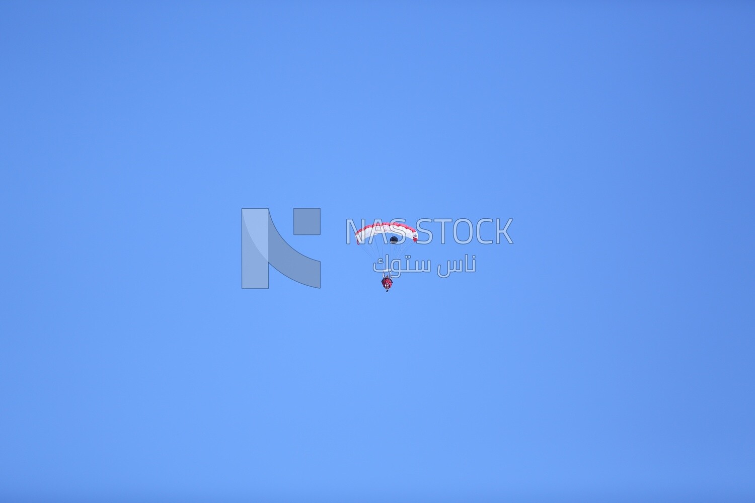 A scene of a person jumping with a parachute