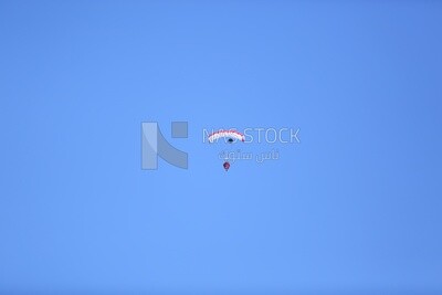A scene of a person jumping with a parachute