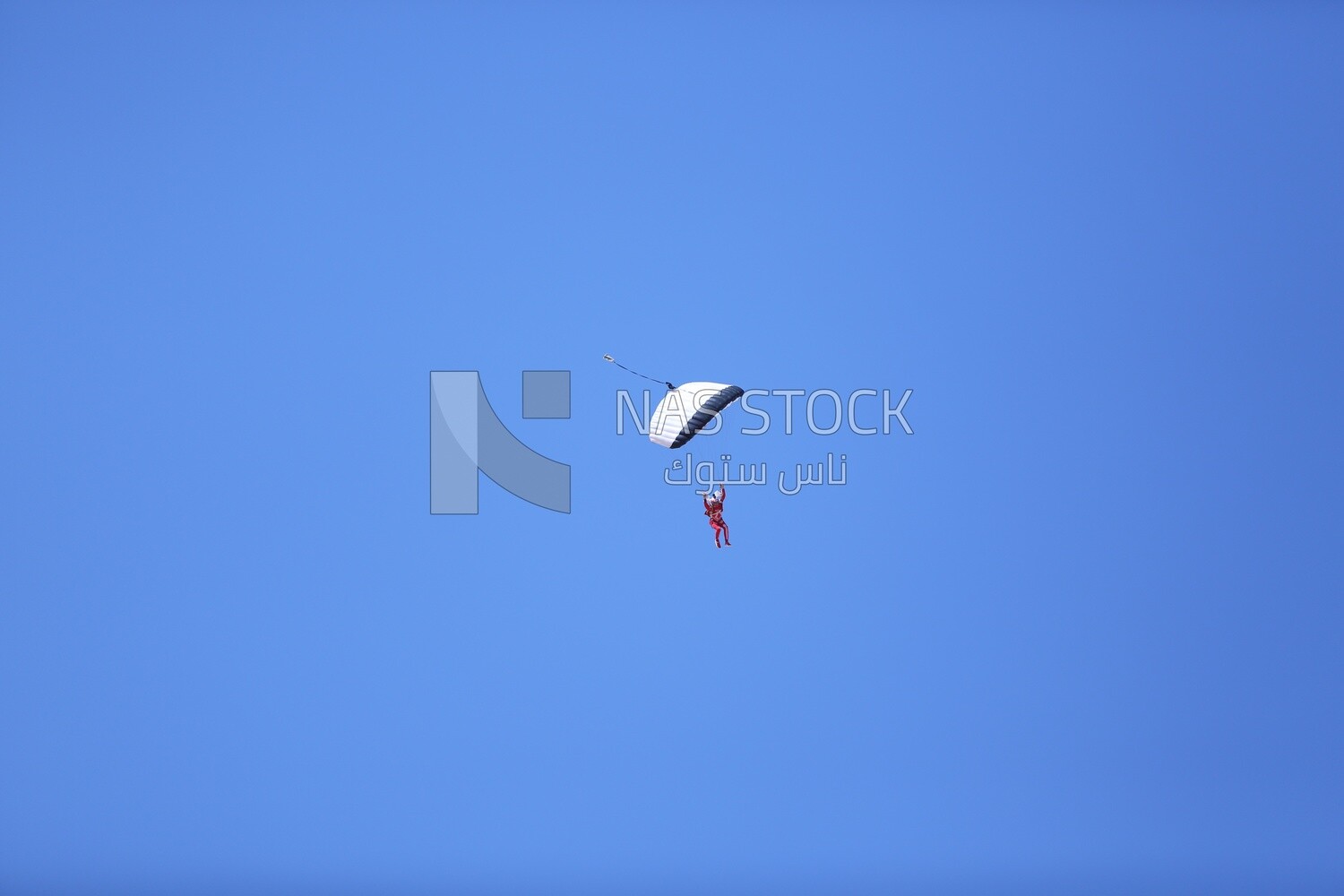 A scene of a person jumping with a parachute