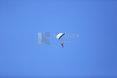 A scene of a person jumping with a parachute