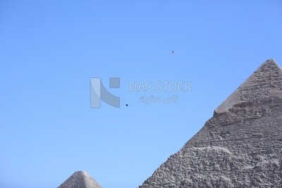 A scene of people skydiving over the pyramids