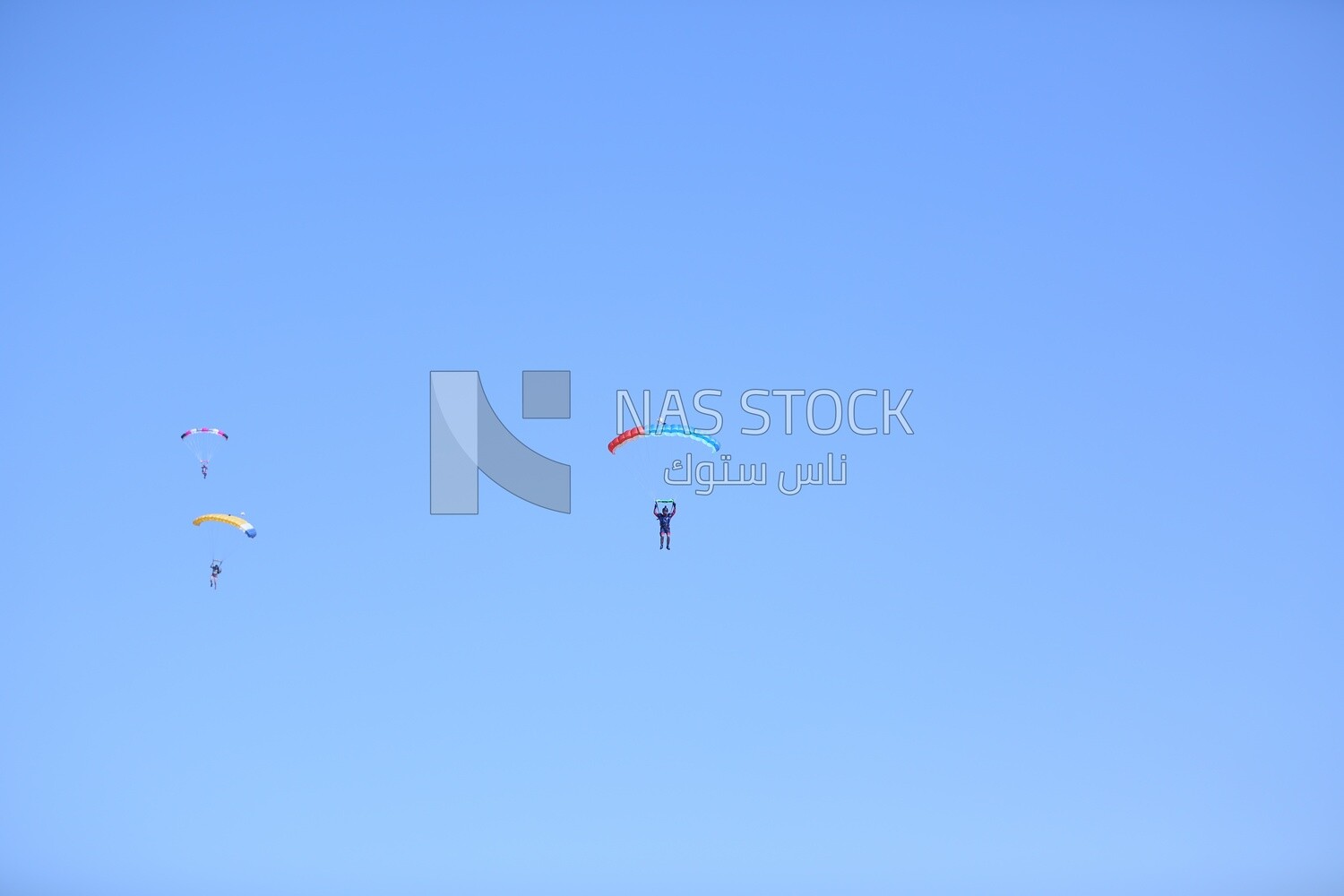 Scene of a person flying in the sky wearing a parachute