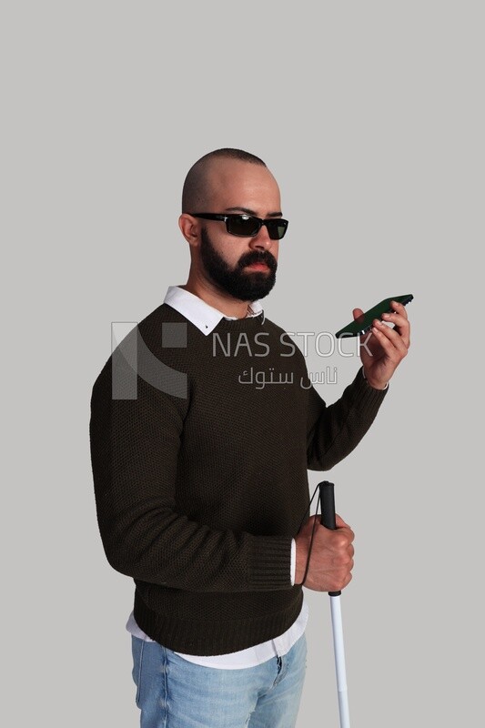 blind man making a phone call using a speaker