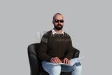 blind man wearing glasses and using Braille to read a book