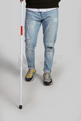 lower half of a blind man with a  walking stick