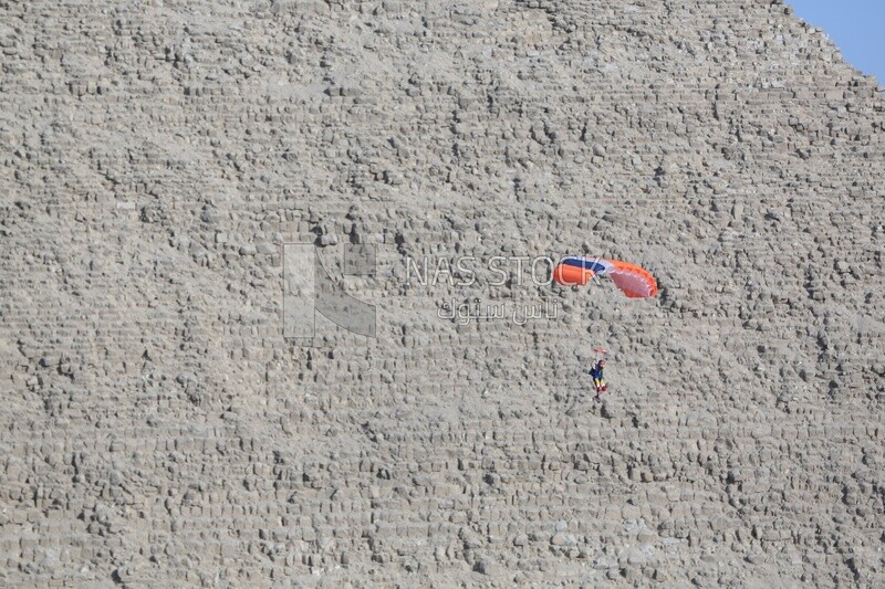 A person parachuting over the Egyptian pyramids