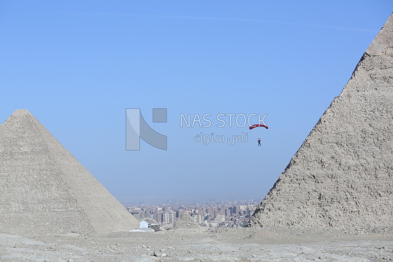 A person about to land with a parachute next to the Great Pyramid in Egypt