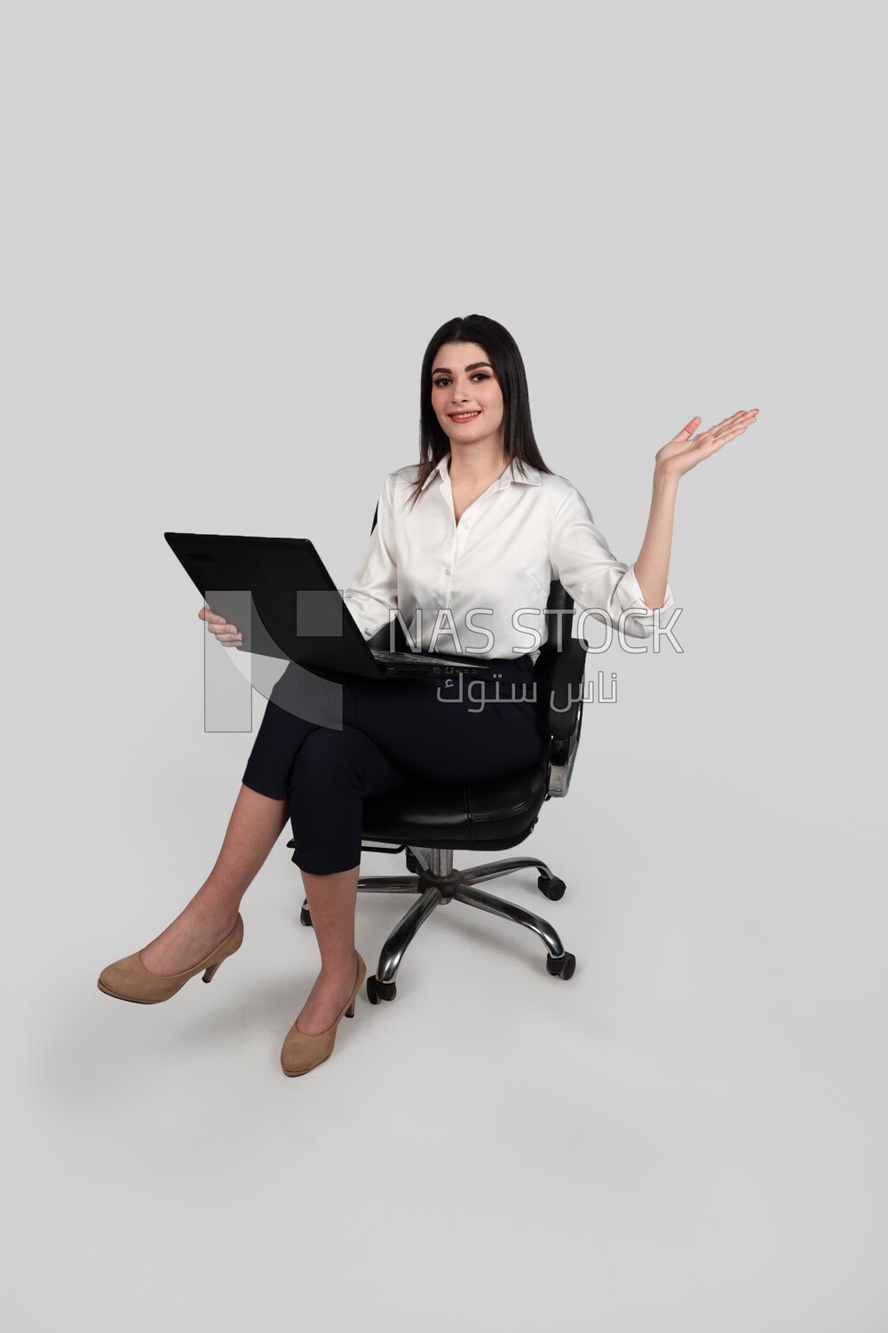 Photo of a businesswoman with formal wear sitting on a chair working on a laptop, business development and partnerships, business meeting, Model
