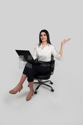 Photo of a businesswoman with formal wear sitting on a chair working on a laptop, business development and partnerships, business meeting, Model