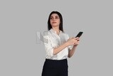 Photo of a businesswoman with formal wear checking the phone, business development and partnerships, business meeting, Model