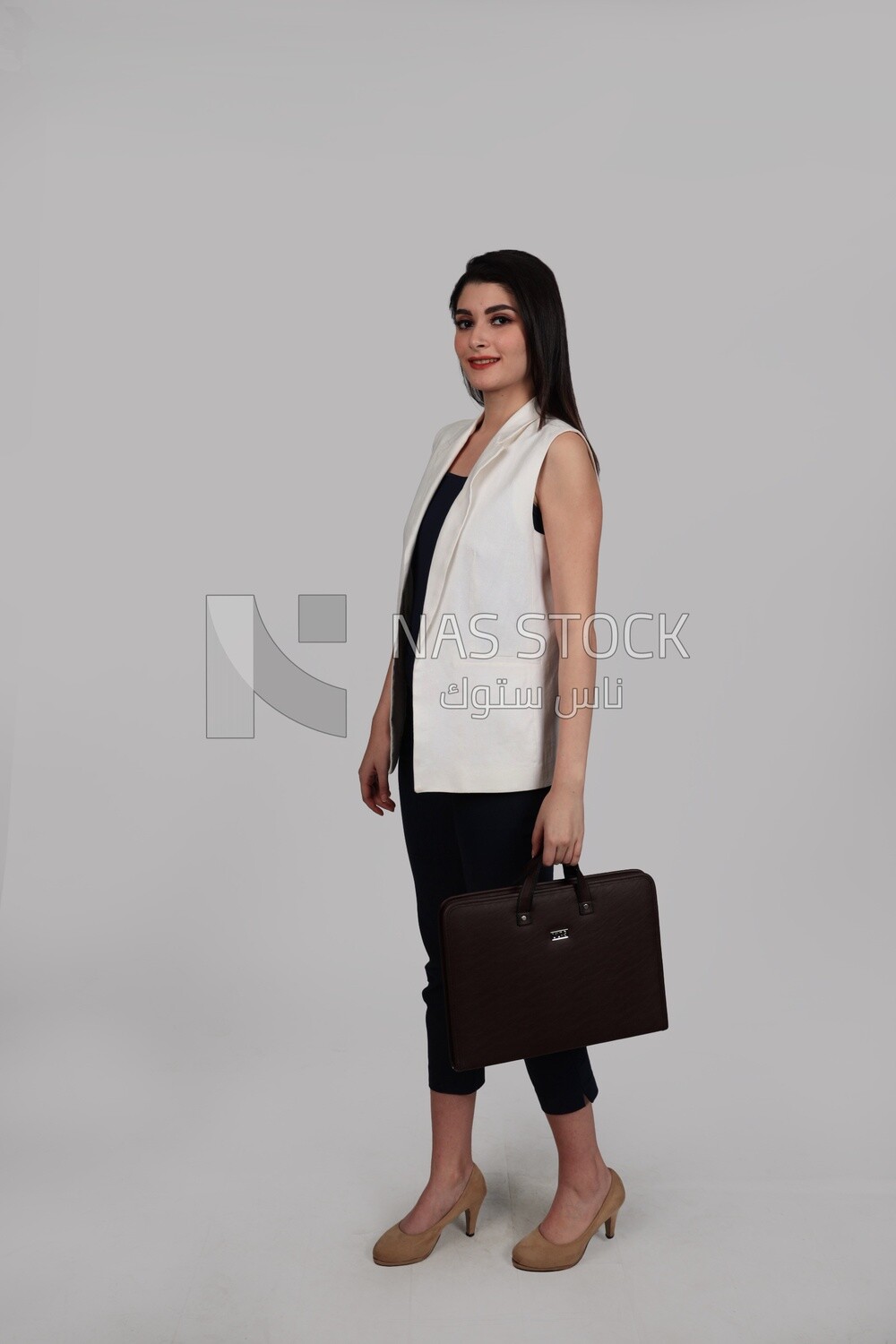 Photo of a businesswoman with formal wear holding a leather bag, business development and partnerships, business meeting, Model