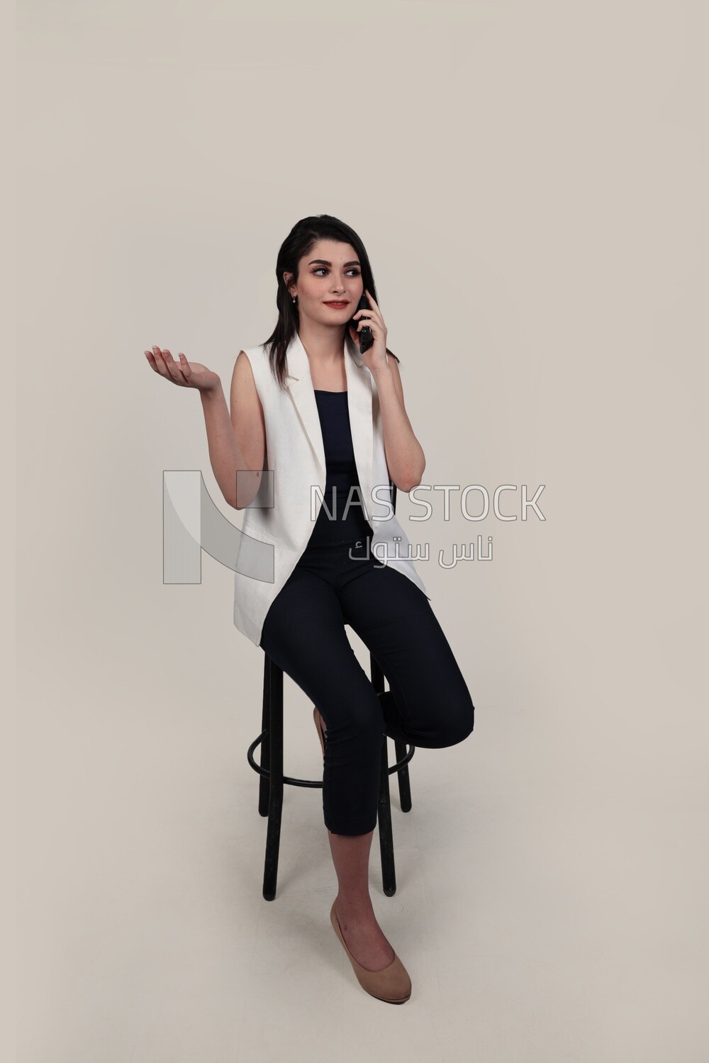 Photo of a businesswoman with formal wear sitting on a chair talking on the phone, business development and partnerships, business meeting, Model