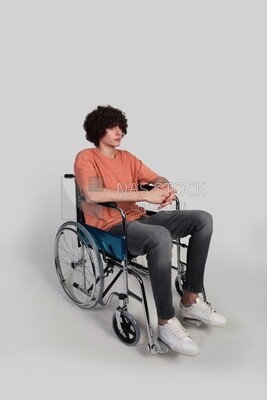 boy sitting in a wheelchair, patient, the concept of medicine and health care, an appointment to receive treatment in the hospital, emergency.