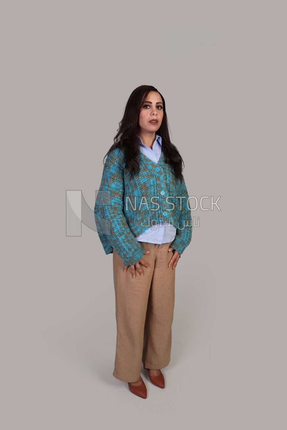 beautiful girl with long brown hair standing politely