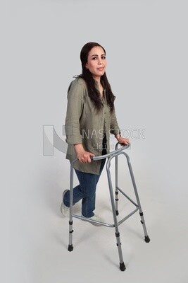 woman with an injured leg walking with crutches, patient, medicine and health care concept, medical professions and jobs.