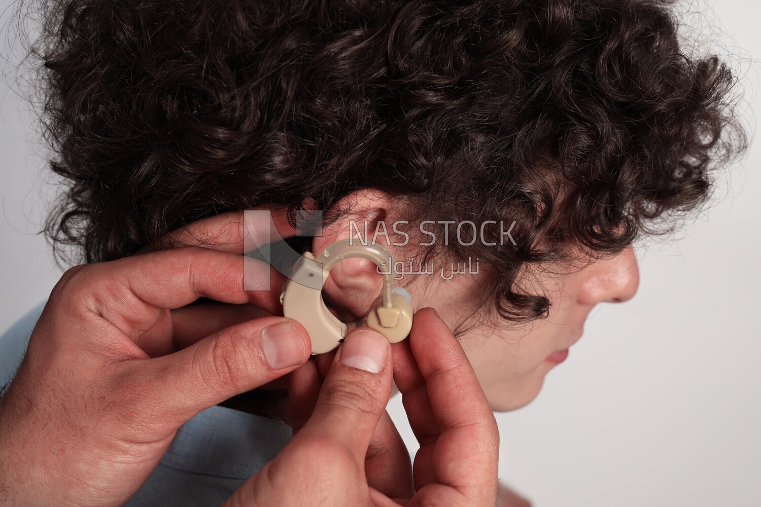 man sitting in a wheelchair holding dumbbells, patient, the concept of medicine and health care, an appointment to receive treatment in the hospital, emergency.