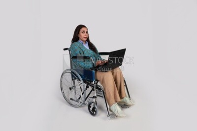 beautiful girl with a disability sitting in a wheelchair