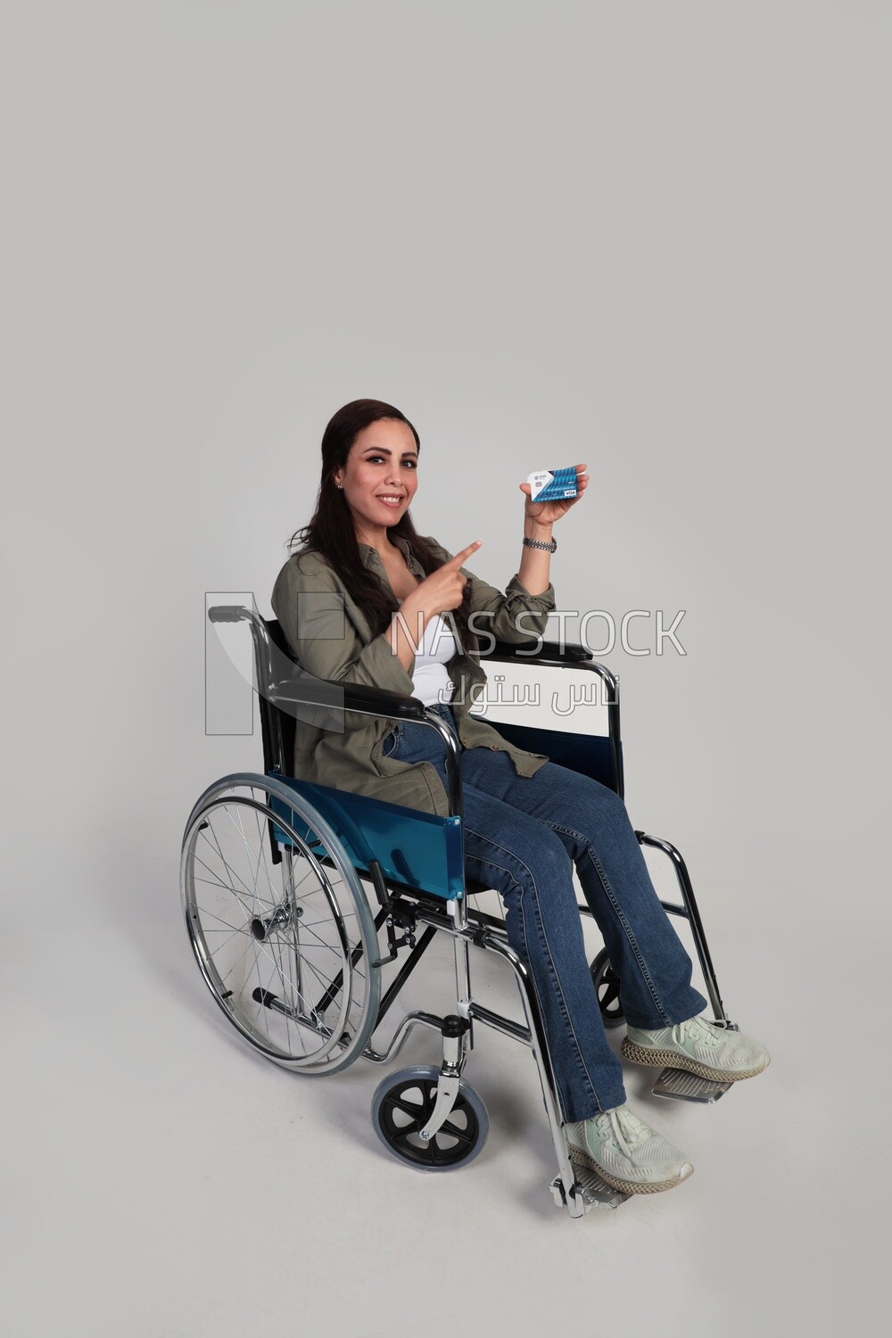 woman sitting in a wheelchair holding a credit card, patient, the concept of medicine and health care, an appointment to receive treatment in the hospital, emergency.