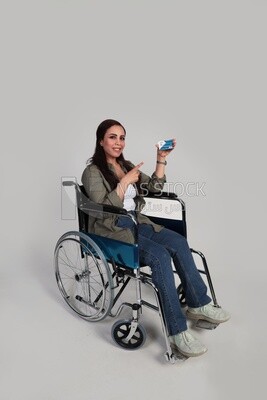 woman sitting in a wheelchair holding a credit card, patient, the concept of medicine and health care, an appointment to receive treatment in the hospital, emergency.