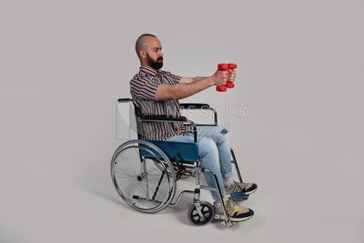 man sitting in a wheelchair holding dumbbells, patient, the concept of medicine and health care, an appointment to receive treatment in the hospital, emergency.
