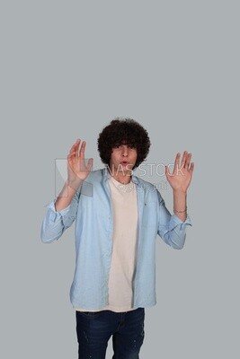 young man wearing a shirt standing amazed