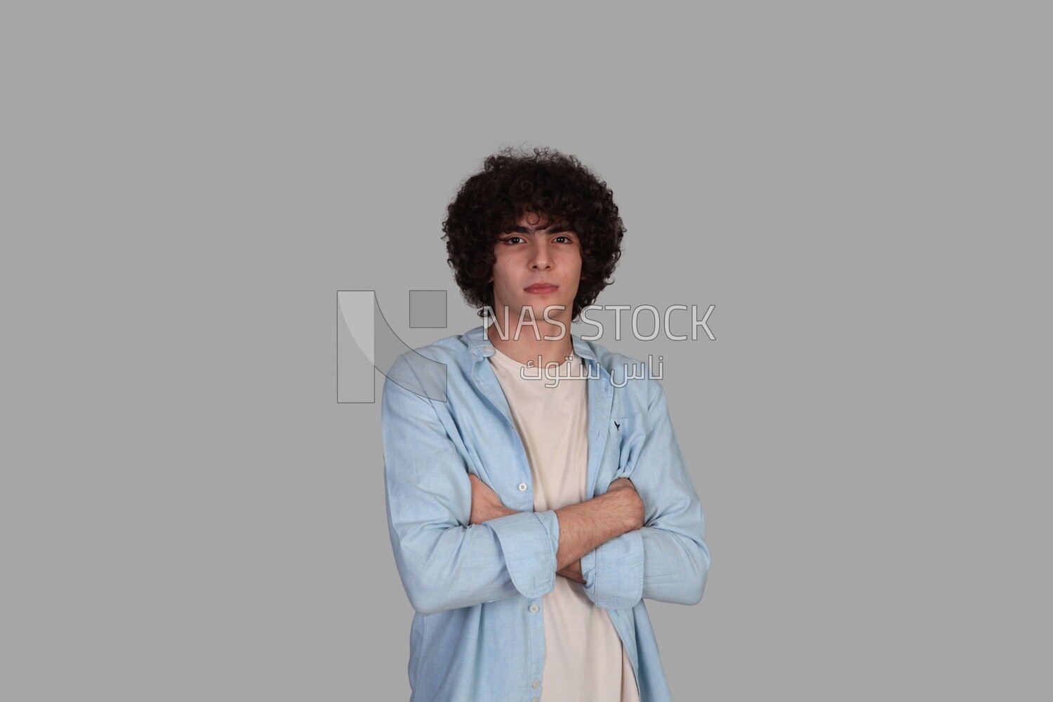 young man with curly hair wearing a shirt