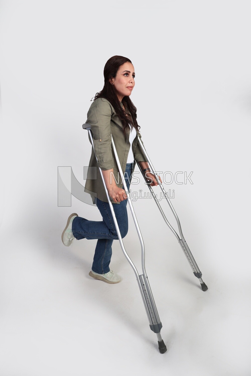 woman with an injured leg walking with crutches, patient, medicine and health care concept, medical professions and jobs.