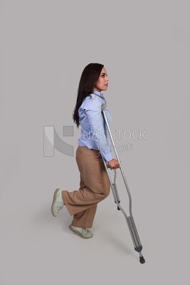 woman with an injured leg walking with crutches, patient, medicine and health care concept, medical professions and jobs.