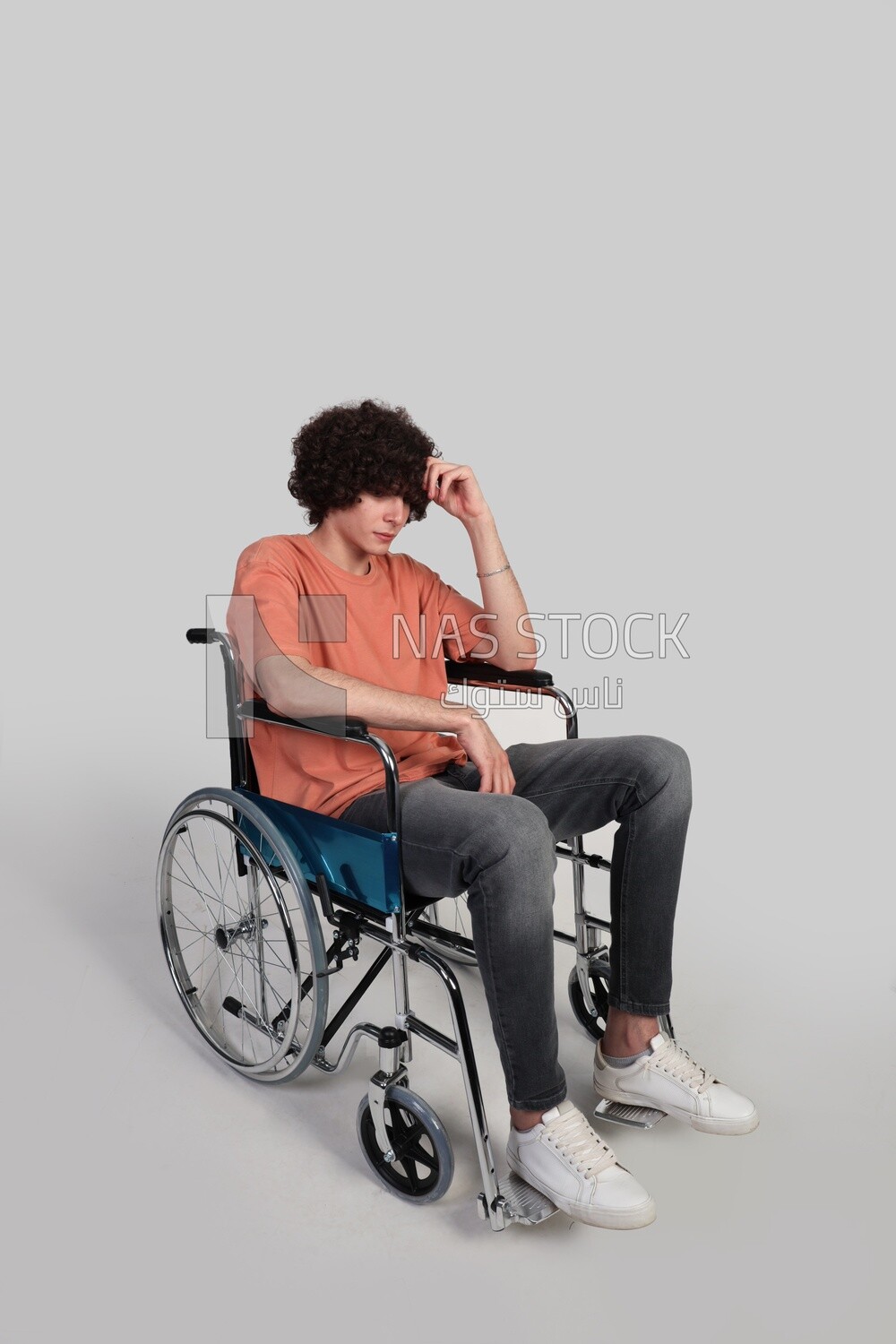 man sitting in a wheelchair holding dumbbells, patient, the concept of medicine and health care, an appointment to receive treatment in the hospital, emergency.