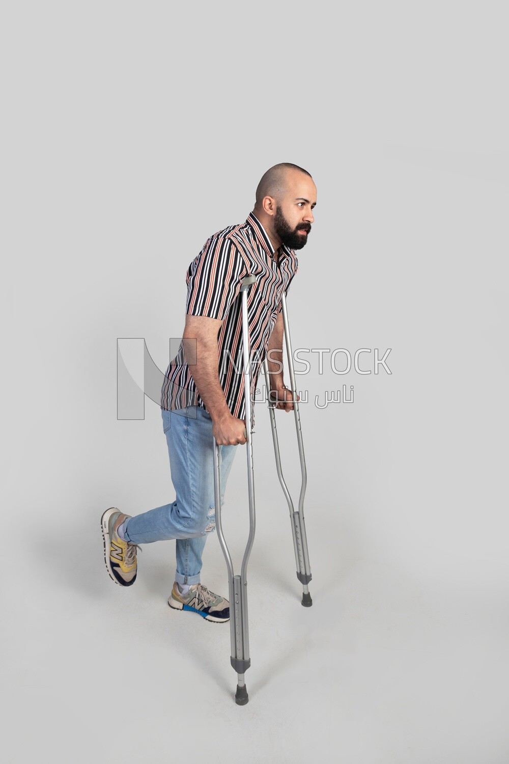 man with an injured leg walking with crutches, patient, medicine and health care concept, medical professions and jobs.