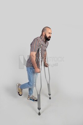 man with an injured leg walking with crutches, patient, medicine and health care concept, medical professions and jobs.