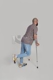 back view of a man with an injured leg walking with crutches, patient, medicine and health care concept, medical professions and jobs.